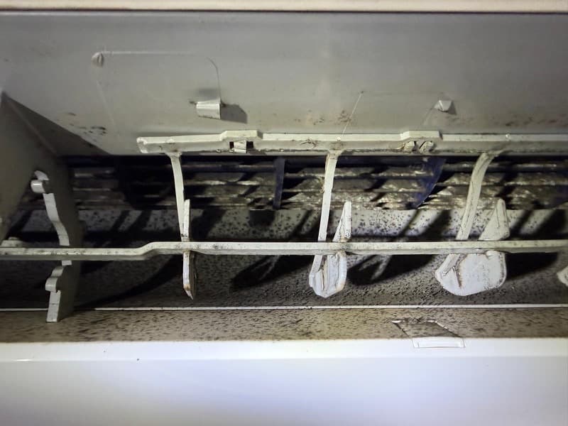 Dirty ductless mini-split interior with dust and mould buildup